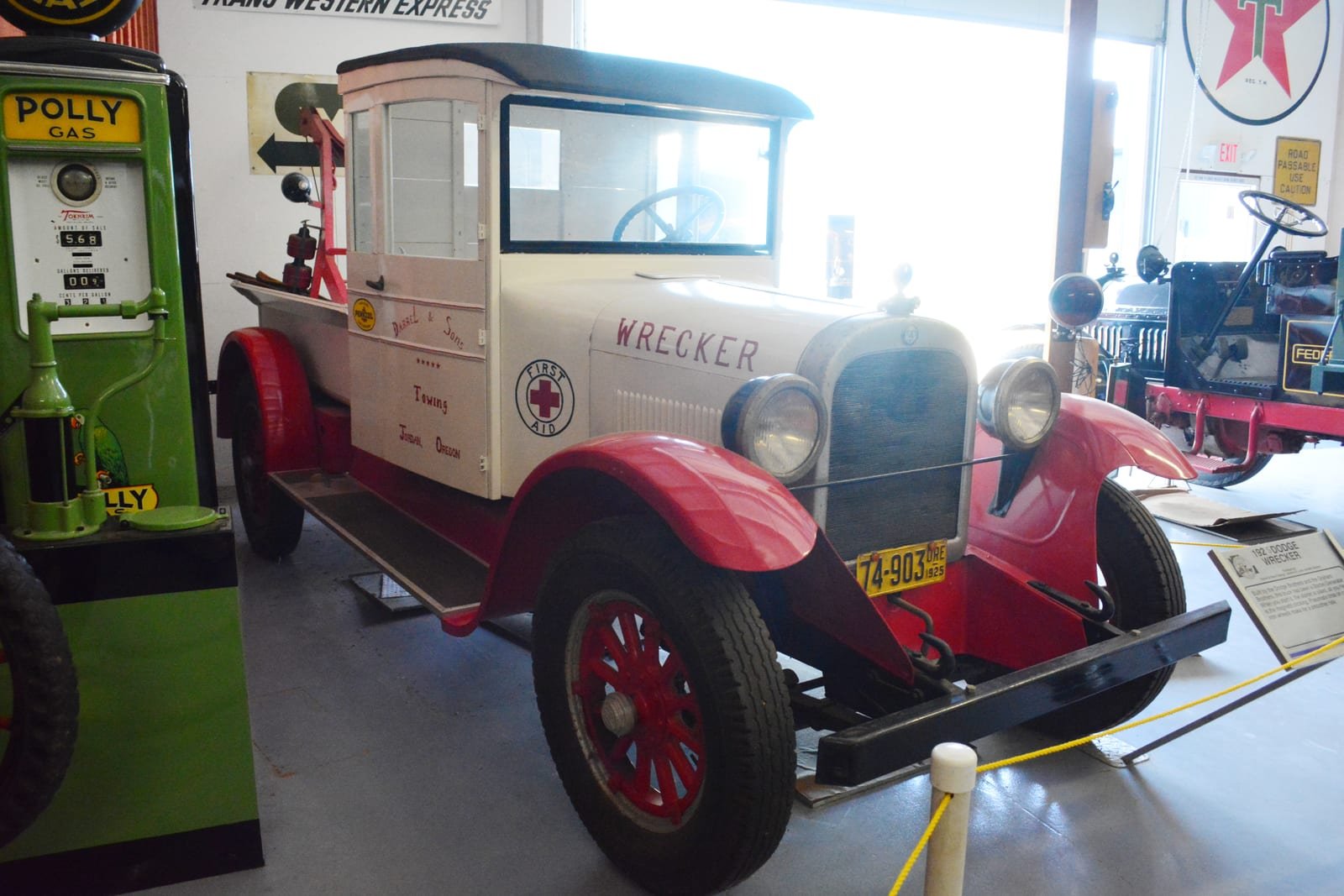 Illustrative image: a 1925 Dodge wrecker tow truck on display in a museum.